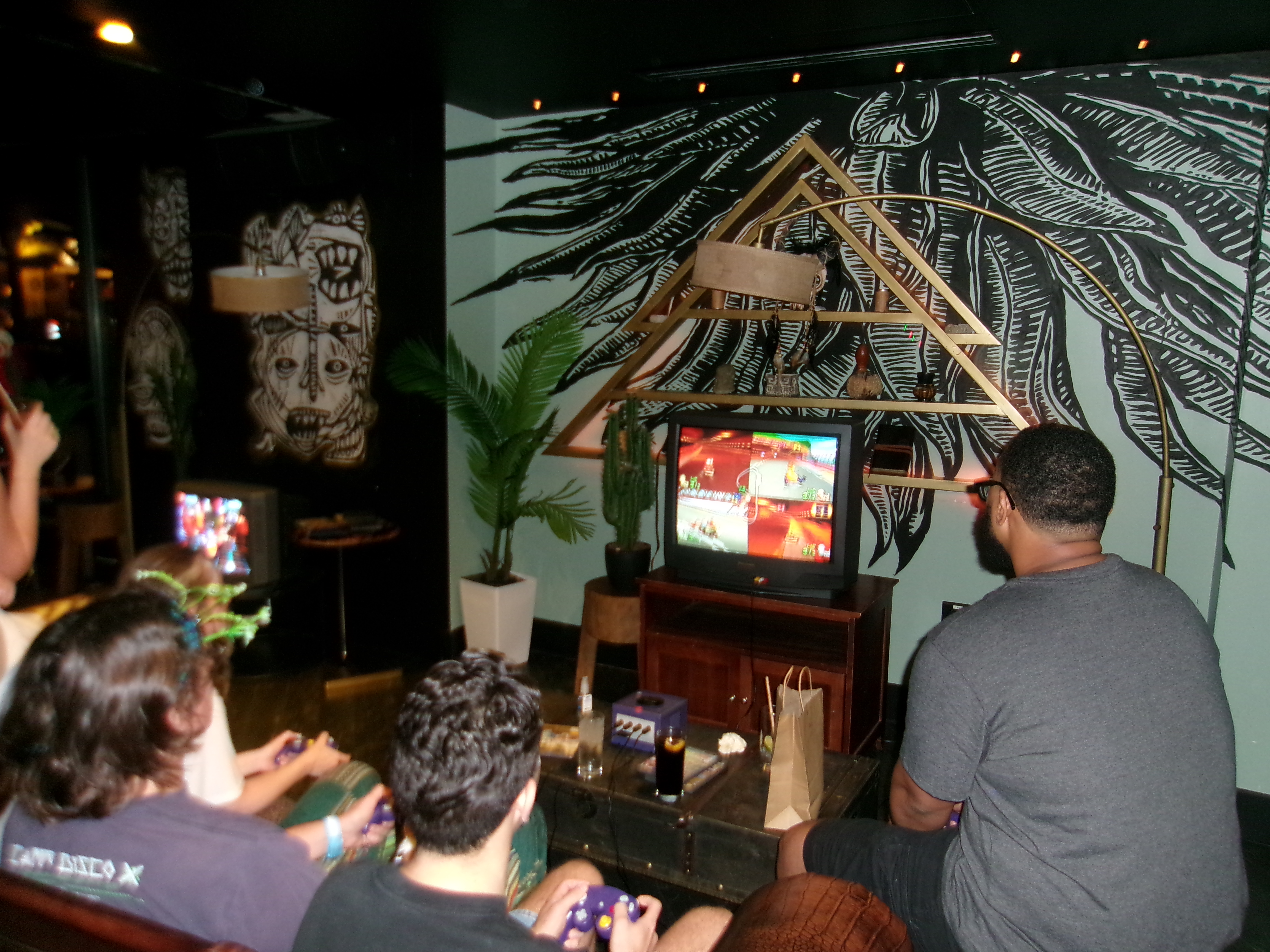 Friends playing Mario Kart together on a CRT television