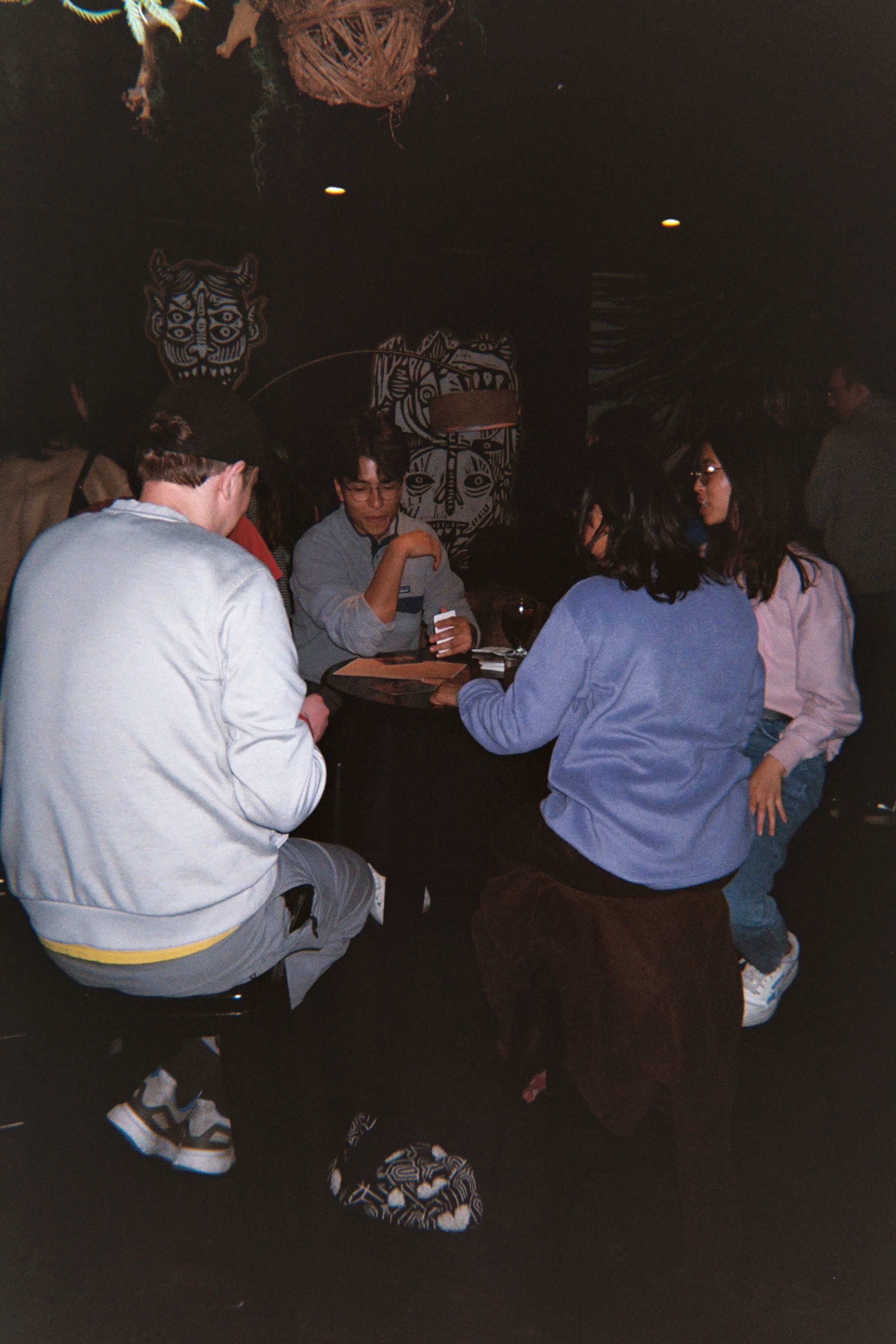 Friends gathered around a table at Reset